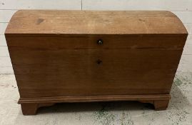 An 19th Century German oak chest with hinged lid opening to storage, two drawers and candle box (