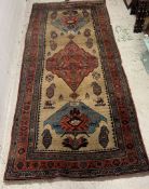 Antique carpet/rug, three central medallions with a red boarder 294cm x 135cm