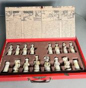 Chinese box chess set, the red lacquered box opens to moulded compartments holding the chess