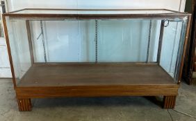 A vintage haberdashery glass cabinet, classic shop counter with glass sliding doors and internal