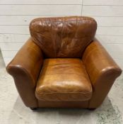 A brown leather club arm chair