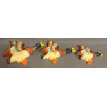 A set of three graduated wall hanging flying ducks