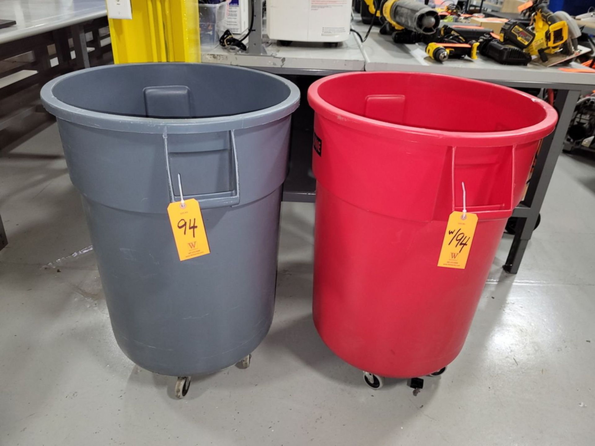 Lot - (2) Uline 55-Gallon Poly Trash Cans; Both Include Dolly