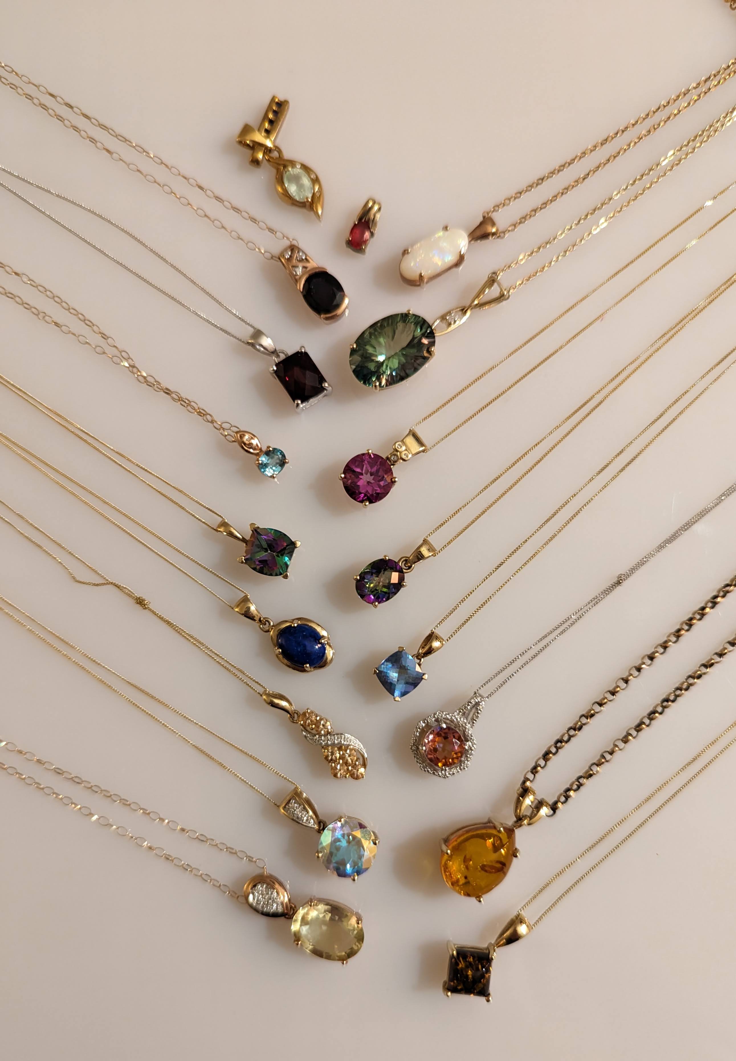 An assortment of sixteen gem-set pendant neck chains in 9ct yellow, rose and white gold,