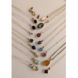 An assortment of sixteen gem-set pendant neck chains in 9ct yellow, rose and white gold,