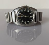 A CWC British military issue stainless steel wristwatch, 1979, with black dial, military arrow, circ