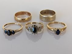 Three sapphire and diamond rings and two etched gold bands, all hallmarked 9ct gold, mixed sizes