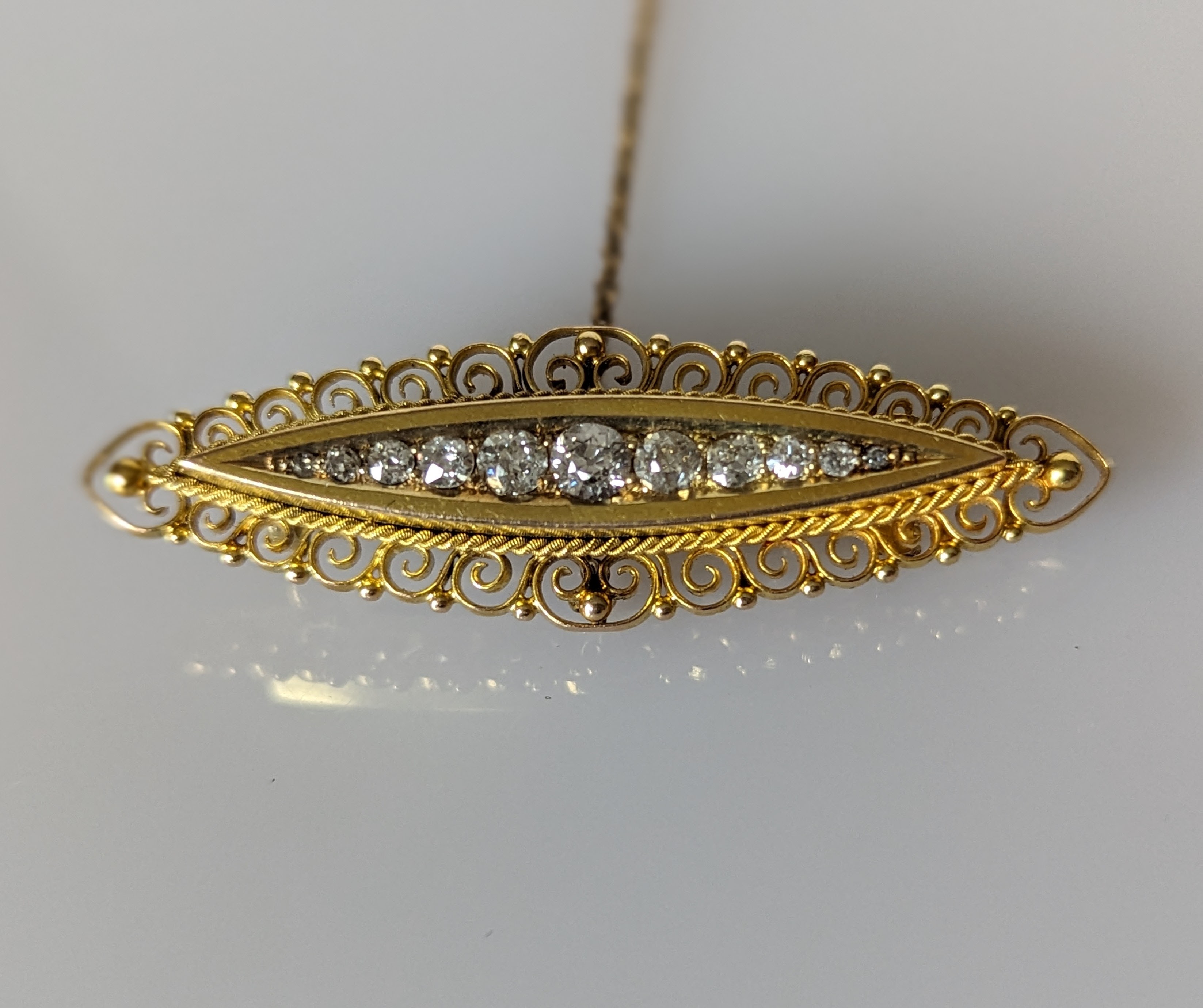 A Victorian-style  yellow gold bar brooch with pave-set round-cut diamonds, largest 0.15 carats