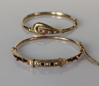 An Etruscan-style gold hinged bangle with sapphire and seed pearl decoration, stamped 9ct