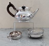 A George III silver teapot of oval form with wood loop handle and knop, on a circular raised foot