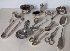 A miscellany of silver items, mostly 19th century, comprising tea strainer, sugar nips, condiments