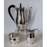 A contemporary silver coffee service comprising coffee pot with wood handle, 26 cm H, cream jug