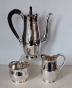 A contemporary silver coffee service comprising coffee pot with wood handle, 26 cm H, cream jug