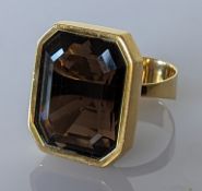 A smokey topaz dress ring in yellow gold, stamped 750 and testing for 18ct, size W, 26.2g