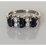 A three-stone graduated sapphire and diamond ring on a white gold setting