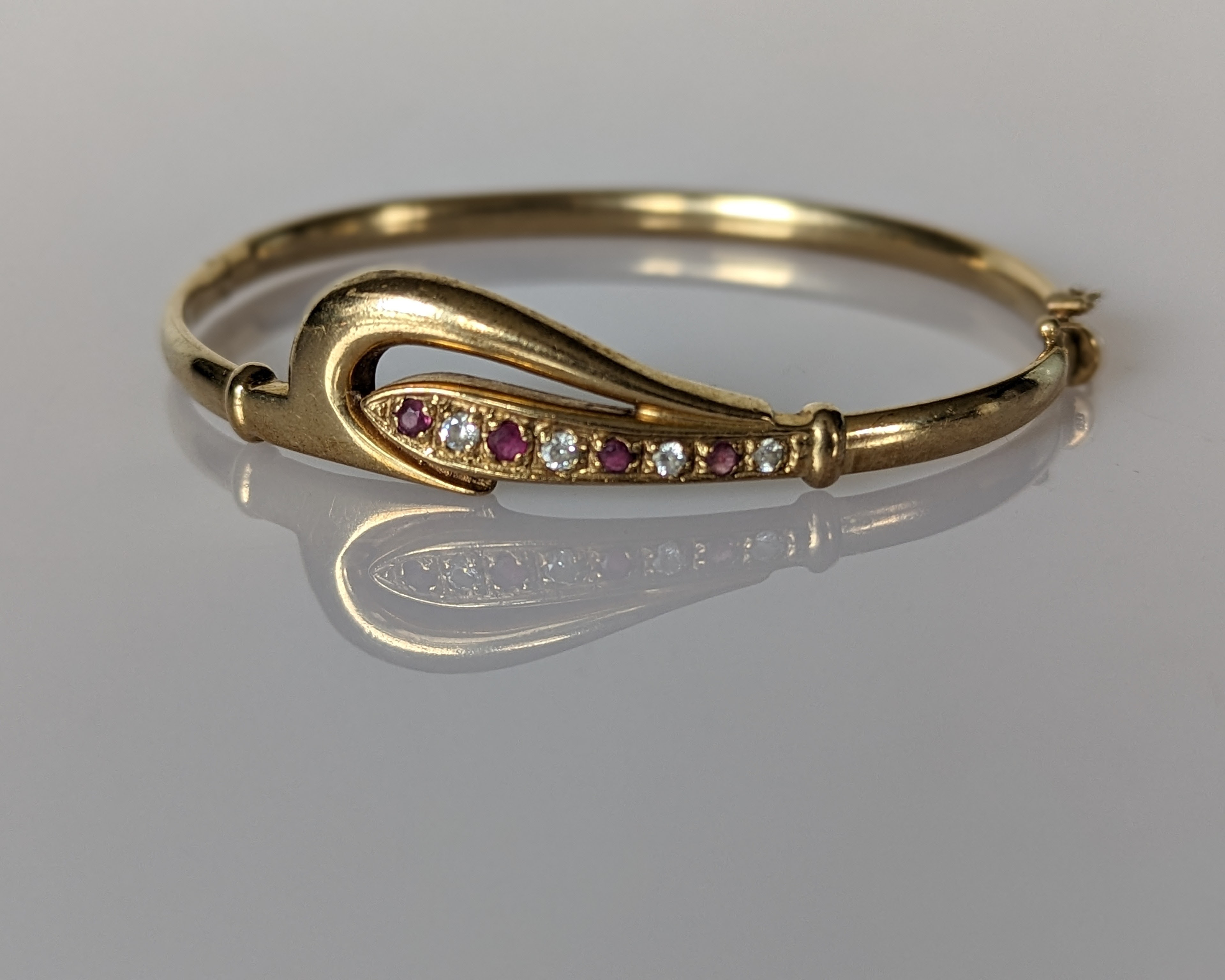 An Etruscan-style gold hinged bangle with sapphire and seed pearl decoration, stamped 9ct - Image 3 of 4