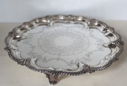 An Edwardian silver circular salver with pie-crust border, applied gadroon rim