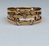 A yellow gold split shank ring with diamond decoration, size O, unmarked but test for 14ct, 4.2g