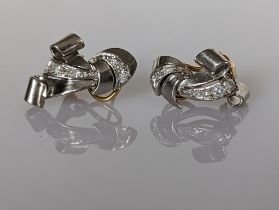 A pair of diamond earrings on white and yellow gold