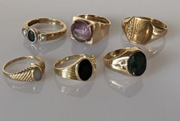 An assortment of five lady size rings set in 9ct yellow gold