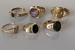 An assortment of five lady size rings set in 9ct yellow gold