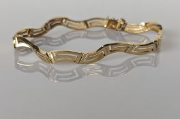 A yellow gold articulated bracelet with stylised greek-key design, 19.5 cm, stamped 585, 8.3g