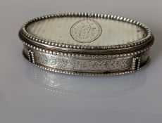 A George III oval silver snuff box with hinged lid, beaded border, engine turned, etched decoration