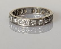 A white gold and diamond eternity ring with twenty round-cut diamonds