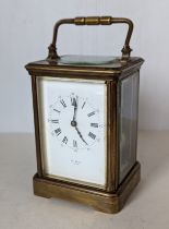 A French brass carriage clock with platform lever escapement, enamel dial with Roman numerals