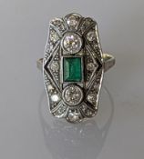 An Art Deco emerald and diamond cocktail ring in white and yellow metal, the emerald 5 x 4mm