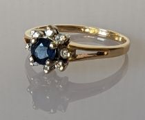 A sapphire and diamond cluster ring on a yellow gold setting, stamped 14k, size R, 2.7g