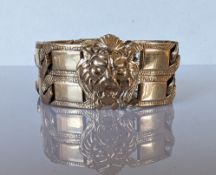 A vintage 9ct gold textured cuff bracelet with lion mask decoration, as found, 21 cm, hallmarked
