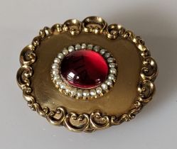 A Victorian oval mourning or memorial brooch/pendant with cabochon and pearl decoration