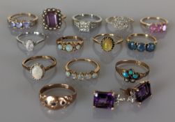 An assortment of thirteen gem-set rings in white and yellow gold together with 4 pair of gem-set ear