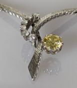 A diamond necklace with a round brilliant-cut diamond weighing an estimated 1.00 carat fancy yellow