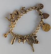 A 9ct yellow gold charm bracelet with assorted gold charms, including a George V half gold sovereign