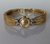 A ladies vintage Omega 18ct gold dress watch with diamond decoration