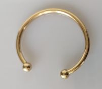 A 9ct yellow gold torque bangle, 55mm, hallmarked, 23.85g