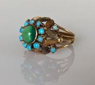 An early 20th century turquoise and gold cluster ring, the central cabochon 8mm diameter 