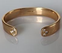 An 18ct yellow gold bangle with diamond decoration, 65mm, hallmarked, 77.4g