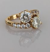 A moissanite 'Moi et Toi' ring on a yellow gold claw setting with cubic zirconia decoration