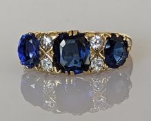 A synthetic sapphire and diamond ring on an 18ct gold setting