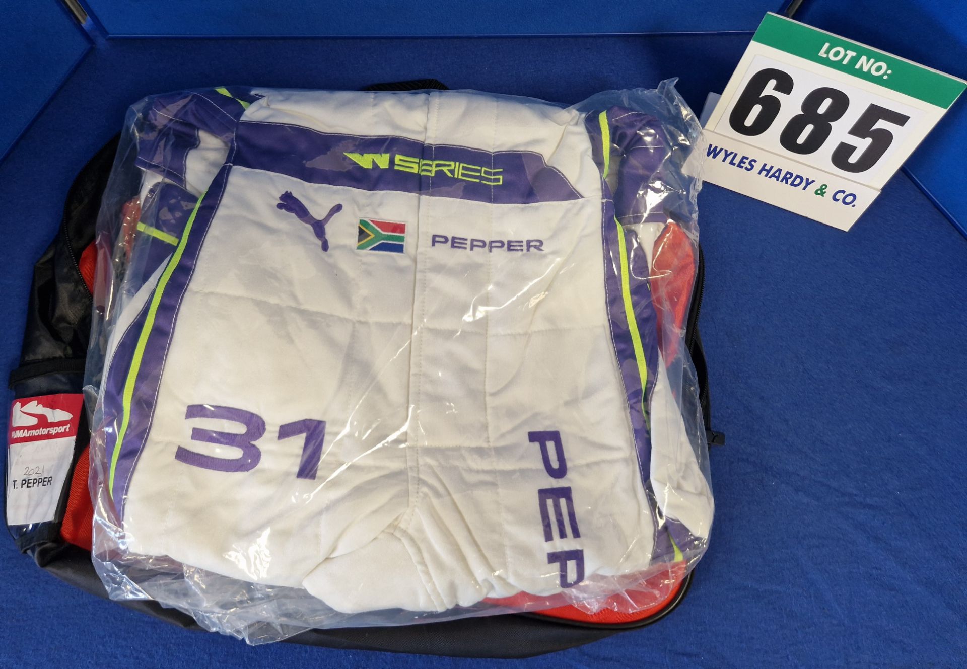 One Unworn PUMA FIA approved Suit (Size - Made to Measure) embroidered with the name T. Pepper in a