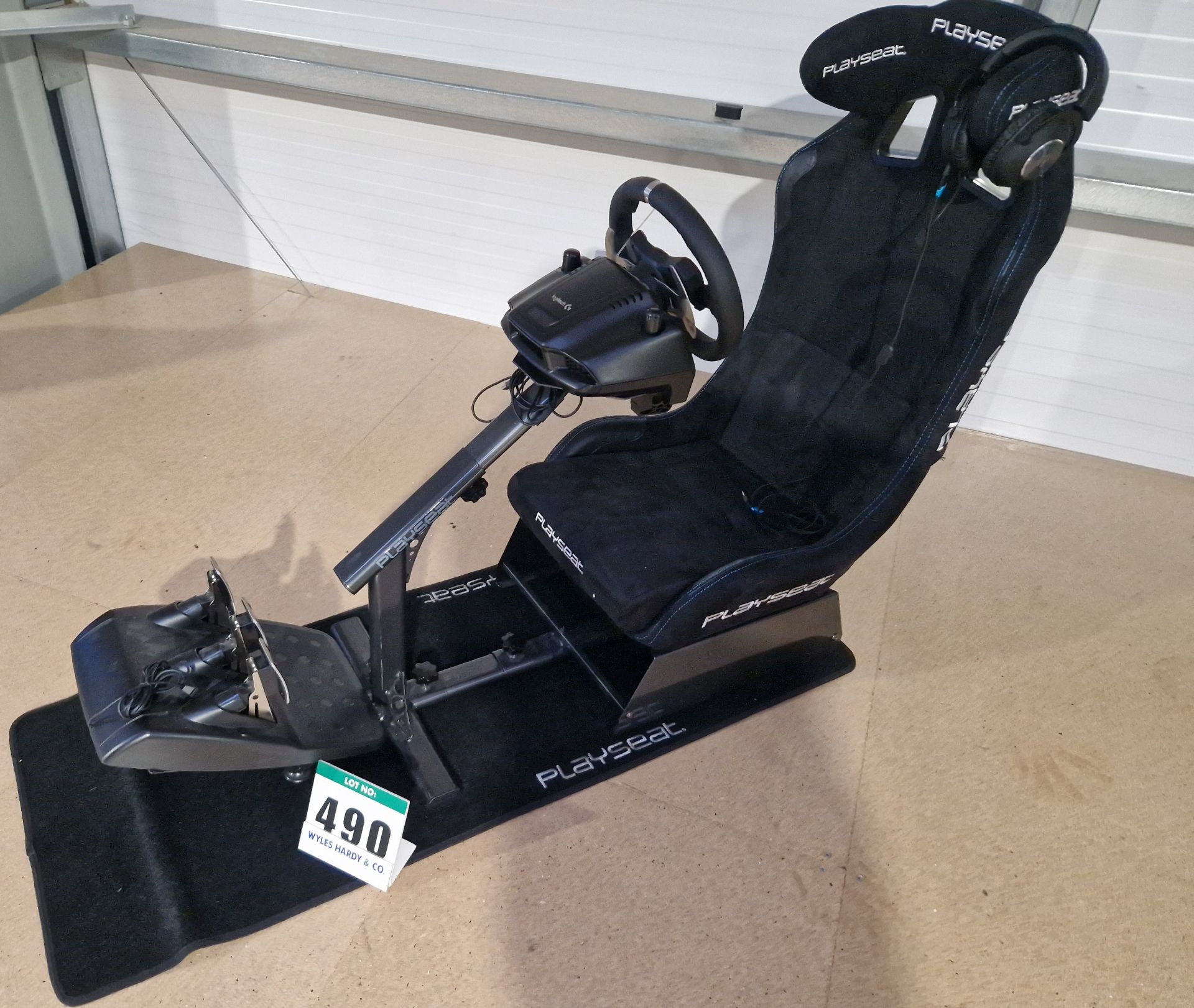 One PLAYSEAT E Sports Gaming Seat and Frame with a LOGITECH Steering Wheel and Pedal Box and a Set