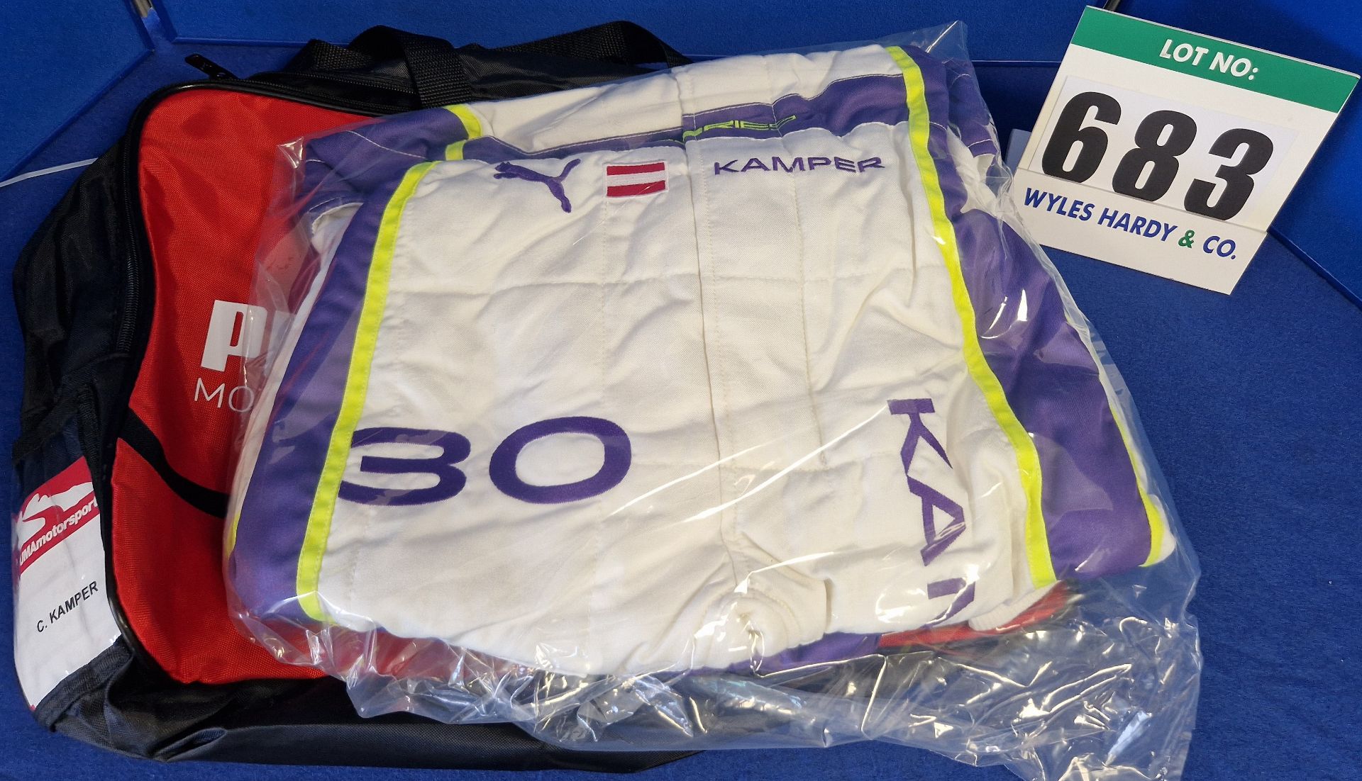 One Unworn PUMA FIA approved Suit (Size - Made to Measure) embroidered with the name C. Kamper in a