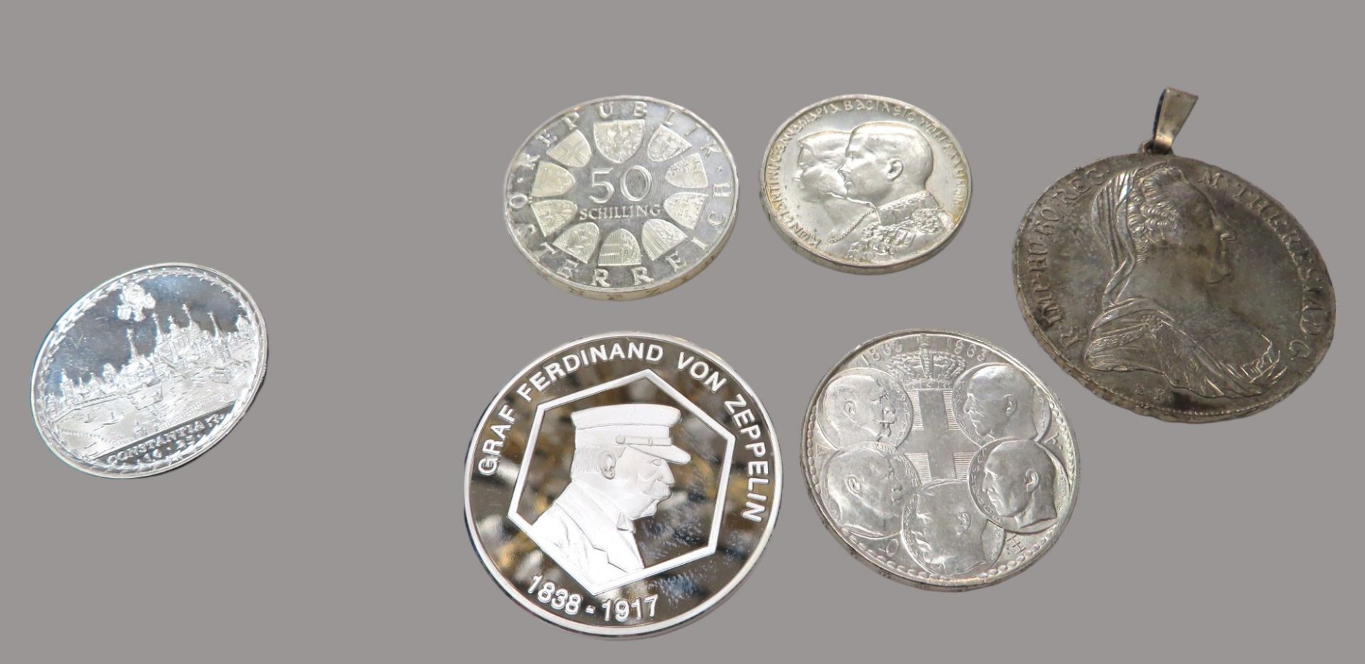 5 diverse Silbermünzen und Gedenkmünze "Graf Zeppelin"; 50-Schilling, Maria-Theresien-Taler, Konsta