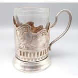 Teeglashalter, Russland, versilberte Montur mit Reliefdekor von Sputnik, gem., h 11 cm, d 11 cm.