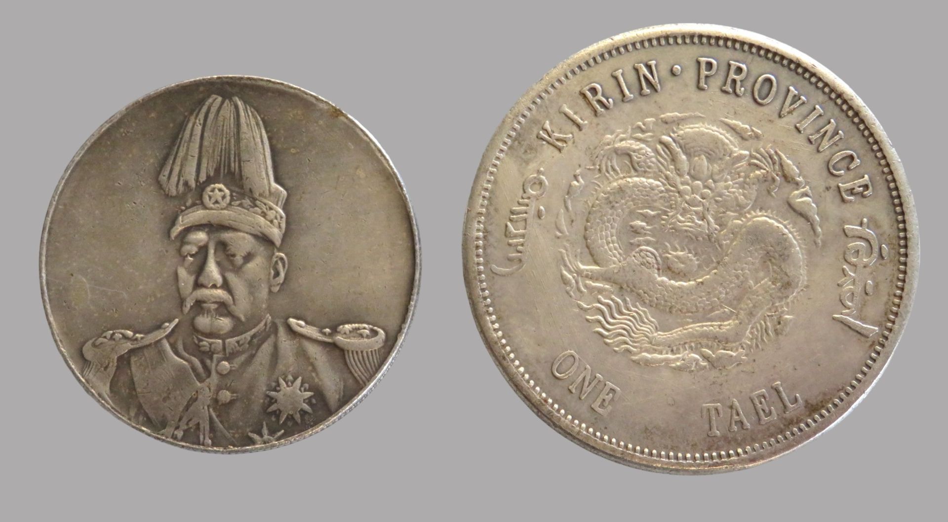 2 Silbermünzen, China, 1 x Kirin Province, One Tael, zus. 44,8 g, d 3,9/4,5 cm.