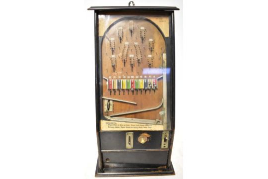 A vintage coin-operated upright table pinball machine, in wooden case ...