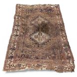 An antique Persian carpet, with central triangular medallions and floral borders, 193 x 133cm.